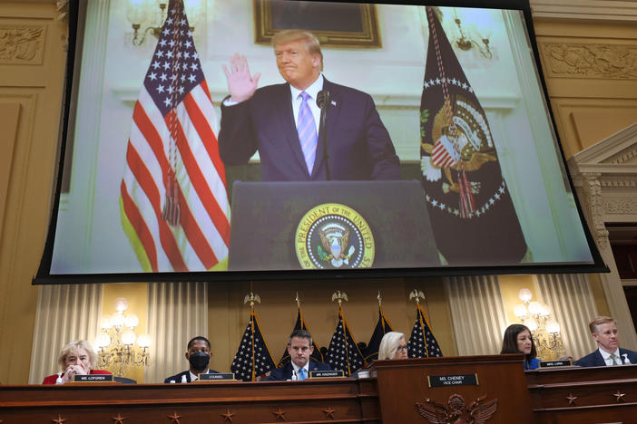 Then-President Donald Trump is seen on the screen above the House select committee investigating the Jan. 6 insurrection on Thursday in outtakes from his Jan. 7, 2021, video in which he refused to say he had lost the election.