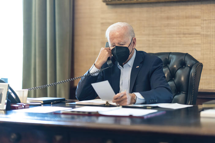 President Biden talks on the phone with his national security team from the Treaty Room in the residence of the White House on Friday.