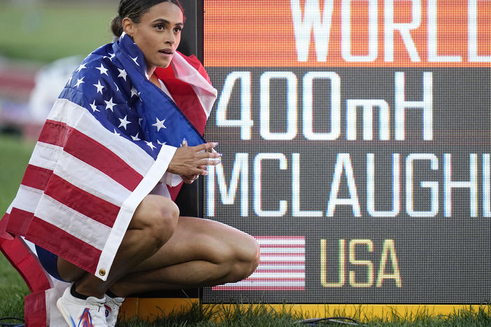 Gold medalist Sydney McLaughlin of the United States poses by a sign after winning the final of the women's 400-meter hurdles at the World Athletics Championships on Friday.