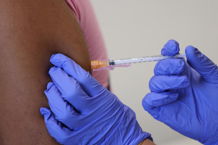 A doctor administers a dose of the monkeypox vaccine on Saturday in London.