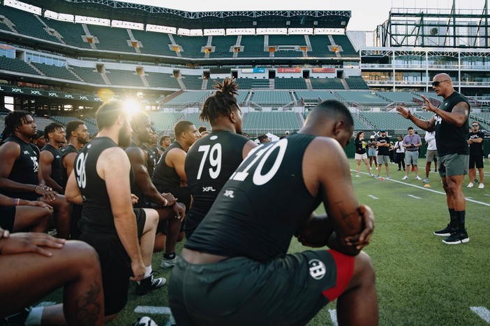 Dwanye "The Rock" Johnson speaks to those participating in the XFL Showcase at Choctaw Stadium in Arlington, Texas, on Sunday.