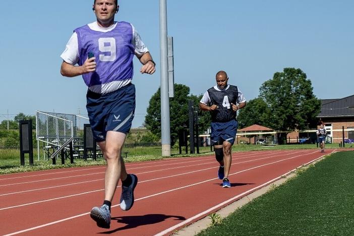 Air Force service members run a timed 1.5 miles during their annual physical fitness test at Scott Air Force Base in Illinois in June. The U.S. Space Force intends to do away with once-a-year assessments in favor of wearable technology.