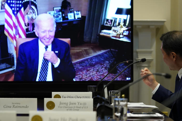 President Joe Biden, on screen at left, listens as SK Group Chairman Chey Tae-won, right, speaks from the Roosevelt Room of the White House on Tuesday.