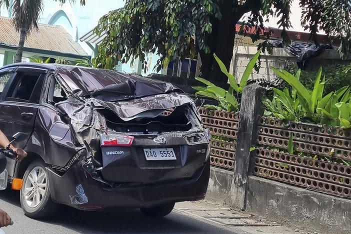 A damaged car is seen along a road after a strong quake hit Bangued, Abra province, in the northern Philippines on Wednesday.