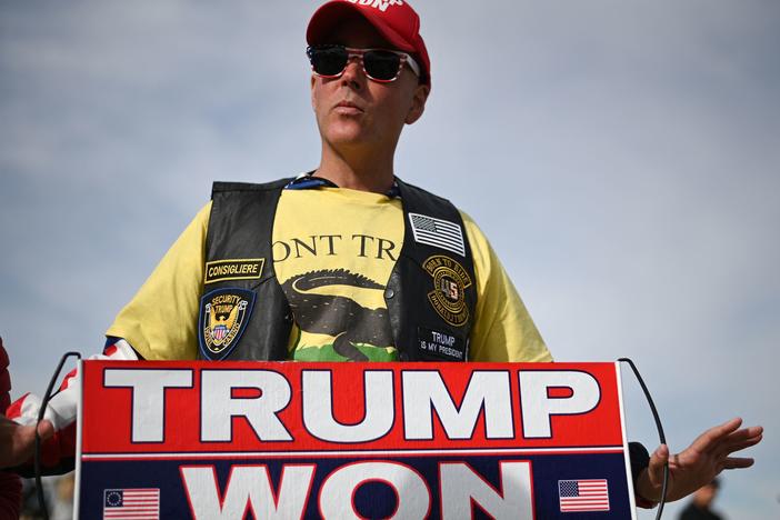 A Donald Trump supporter holds a "Trump Won" sign before a rally on Jan. 15 in Florence, Ariz. The former president, who lost the state and the presidential election in 2020, has endorsed a slew of election-denying candidates in Arizona this year.