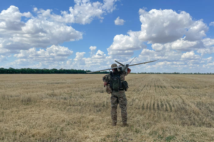 A member of a Ukrainian military surveillance team gets ready to launch a drone from a wheat field in southern Ukraine.