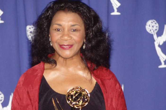 Actress Mary Alice holding her Emmy Award in the press room in 1993.