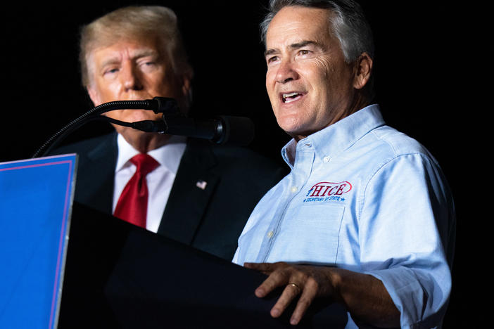 Georgia Rep. Jody Hice speaks during a rally last September as former President Donald Trump looks on. Trump endorsed Hice, who falsely believes fraud tainted the 2020 election, in the Georgia secretary of state race, but Hice was defeated.