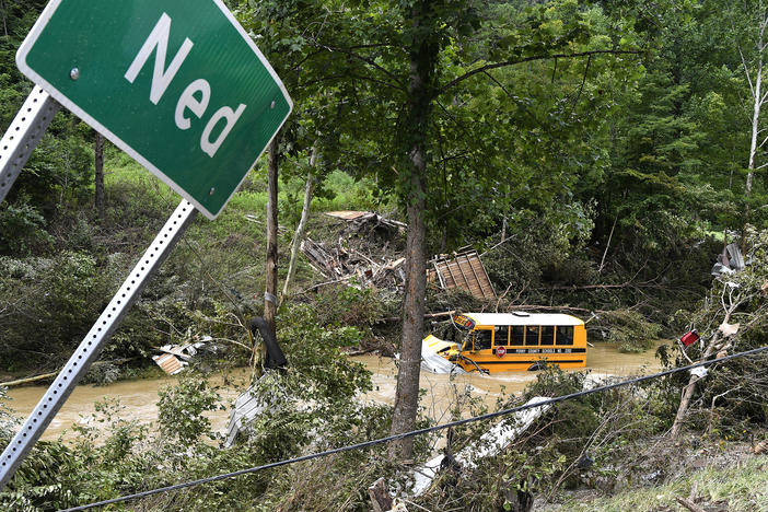 A Perry County school bus lies destroyed after being caught up in the floodwaters of Lost Creek in Ned, Ky., on Friday.