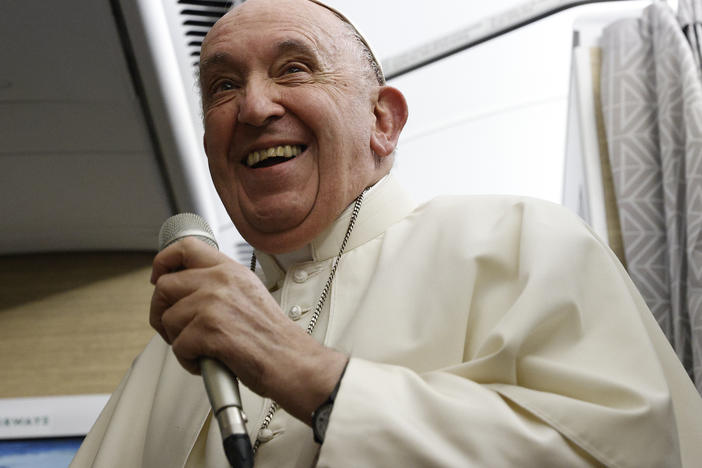 Pope Francis speaks to journalists aboard the papal flight back from Canada on Saturday.