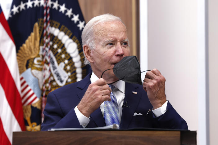 President Biden takes his face mask off on Thursday during a meeting on the U.S. Economy with CEOs and members of his Cabinet in the South Court Auditorium of the White House.