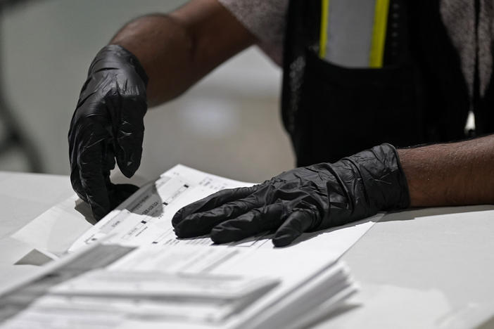 In this Sept. 3, 2020, file photo, a worker prepares absentee ballots for mailing at the Wake County Board of Elections in Raleigh, N.C.
