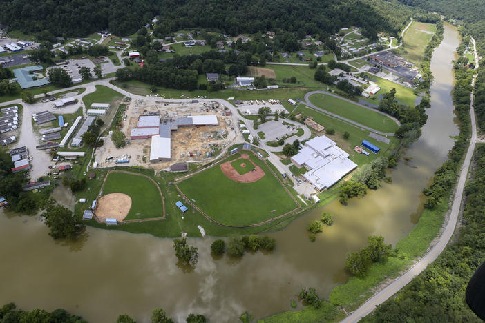 In this aerial image, the river is still high around the homes in Breathitt County, Ky., on Saturday. Recovery has begun in many of the narrow hollers after historic rains flooded many areas of Eastern Kentucky.
