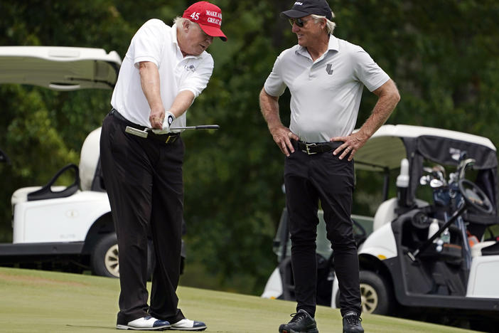 Former President Donald Trump talks with LIV Golf CEO Greg Norman on a green during the pro-am round of the Bedminster Invitational LIV Golf tournament on Thursday.