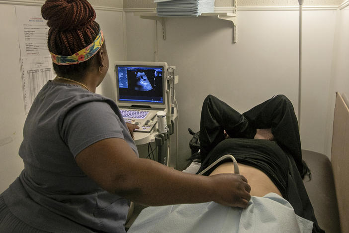 An operating room technician performs an ultrasound on a patient in Shreveport, La., on July 6, 2022.