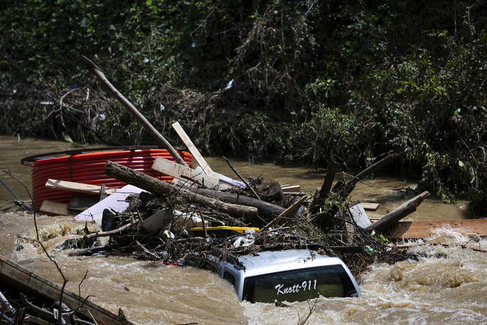 A truck is washed away by floodwaters in the Troublesome Creek near Main Street, in Hindman, Ky., on Monday.