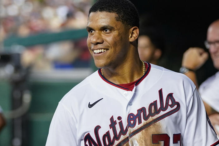 Washington Nationals' Juan Soto smiles in the dugout after a solo home run against the New York Mets at Nationals Park on Monday in Washington.