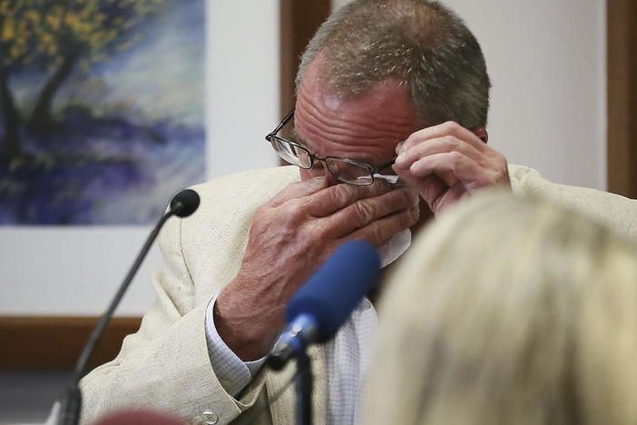 Neil Heslin, father of 6-year-old Sandy Hook shooting victim Jesse Lewis, becomes emotional while testifying in the trial of Alex Jones on Tuesday in Austin, Texas.