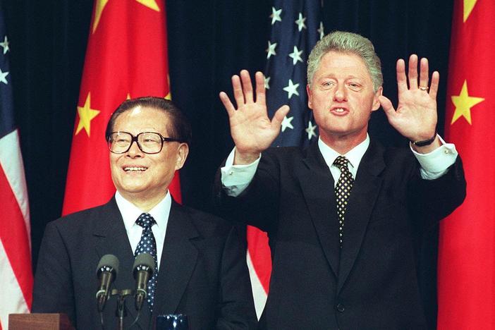 President Bill Clinton holds up his hands indicating no more questions as he and Chinese President Jiang Zemin hold a joint press conference in 1997 in Washington, D.C. Clinton confirmed that he agreed to lift a ban on the export of nuclear power technology to China.