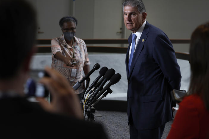 Sen. Joe Manchin, Democrat of West Virginia, speaks to reporters about the compromise bill that could substantially alter a tax provision called the "carried interest loophole."