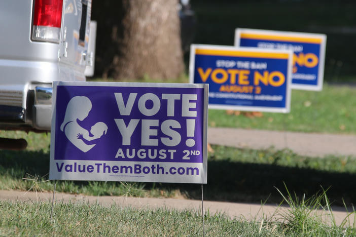 Political signs for the state constitutional amendment vote on abortion rights in Kansas sit near each other in yards in Overland Park, Kan., July 16, 2022.