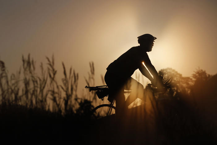 A rider makes their way along RAGBRAI's route on a foggy morning Wednesday, July 28, outside of Emmetsburg, Iowa, on Day 4 of the annual recreational bike ride across the state of Iowa.