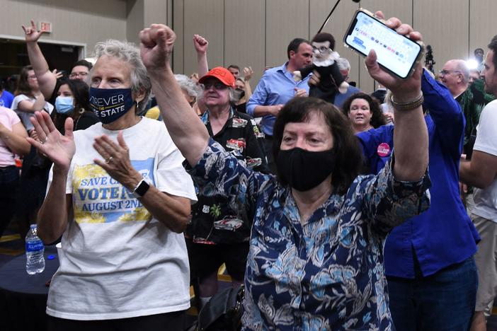 Abortion-rights supporters cheer as the proposed Kansas constitutional amendment that would allow abortion restrictions in the state fails. They were watching election results at the Kansas for Constitutional Freedom watch party in Overland Park.