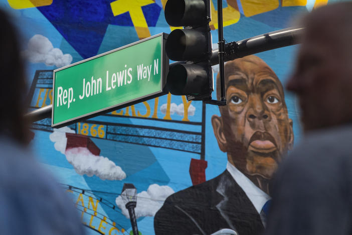 A mural of Rep. John Lewis on a street named after him Feb. 11, in Nashville, Tenn. The late Lewis was part of a movement that marched downtown from the historically Black neighborhood of North Nashville to take part in lunch counter sit-ins. That same neighborhood is redistricted into a mostly white congressional district, which some Democrats are comparing past civil rights violations.