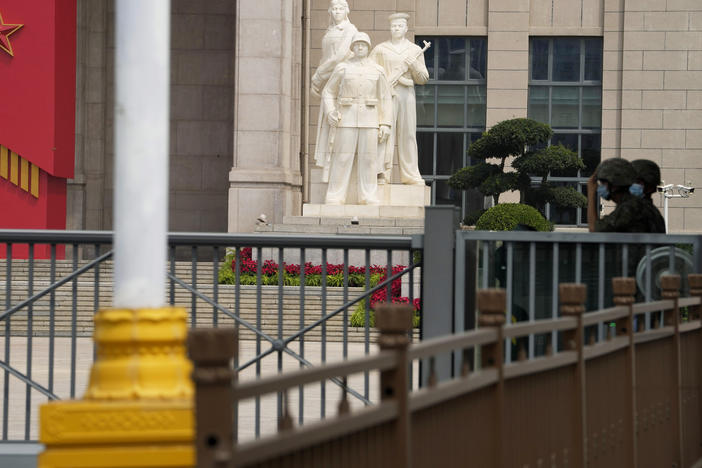 Chinese soldiers wearing masks guard the entrance to the military museum in Beijing on Aug. 1. China says military exercises by its navy, air force and other departments are underway in six zones surrounding Taiwan.