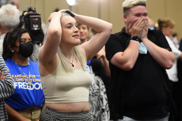 Alie Utley and Joe Moyer react to their county voting against the proposed constitutional amendment during the Kansas for Constitutional Freedom primary election watch party in Overland Park, Kan., on Tuesday.