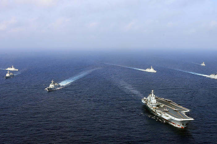 An April 2018 photo provided by the Chinese government shows the country's first aircraft carrier, the Liaoning (front), steaming with other ships during a drill at sea.