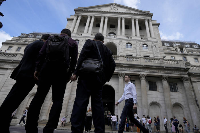 People wait at the Bank of England in London, Thursday, Aug. 4, 2022.