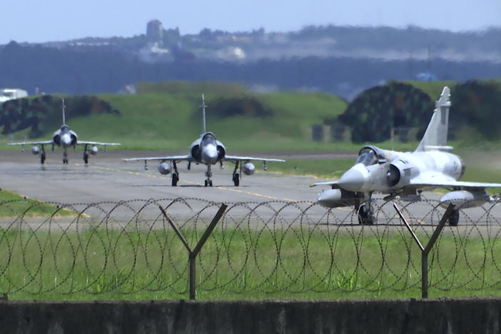 Taiwan Air Force Mirage fighter jets taxi on a runway at an airbase in Hsinchu, Taiwan, on Friday. China says it summoned European diplomats in the country to protest statements issued by the Group of Seven nations and the European Union criticizing threatening Chinese military exercises surrounding Taiwan.