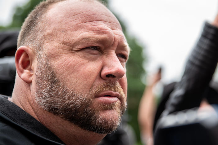 Infowars founder Alex Jones listens to a supporter at the Texas State Capital building in April 2020 in Austin, Texas.