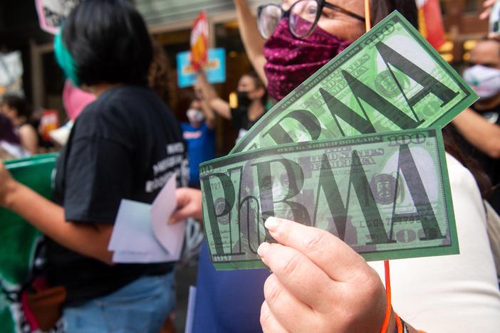 Demonstrators outside PhRMA headquarters in Washington, D.C., protest lobbying by pharmaceutical companies to keep Medicare from negotiating lower prescription drug prices.