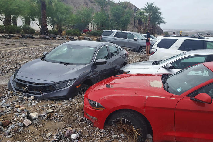 Cars are stuck in mud and debris from flash flooding at The Inn at Death Valley in Death Valley National Park in California on Friday.