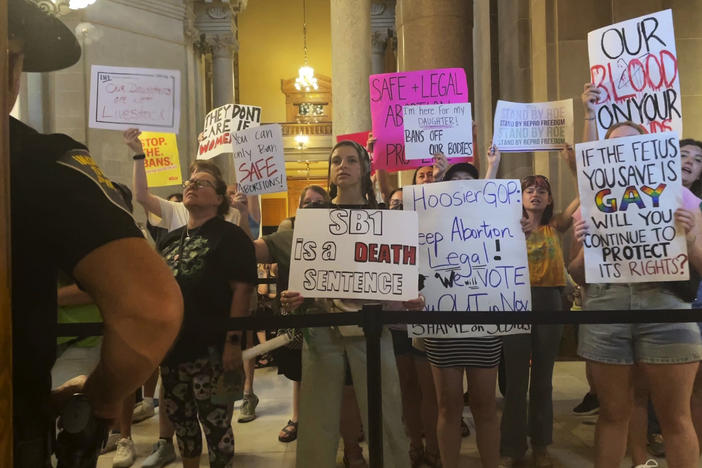 Abortion-rights protesters fill Indiana Statehouse corridors and cheer outside legislative chambers on Friday as lawmakers vote to concur on a near-total abortion ban, in Indianapolis.