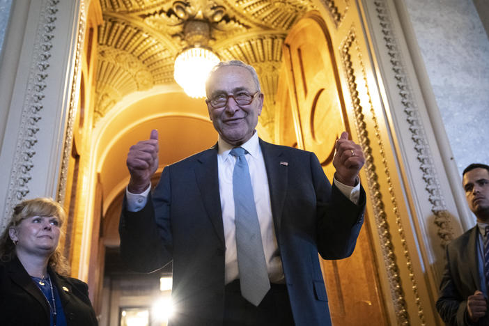 Senate Majority Leader Chuck Schumer gives the thumbs up as he leaves the Senate Chamber after passage of the Inflation Reduction Act on Sunday.