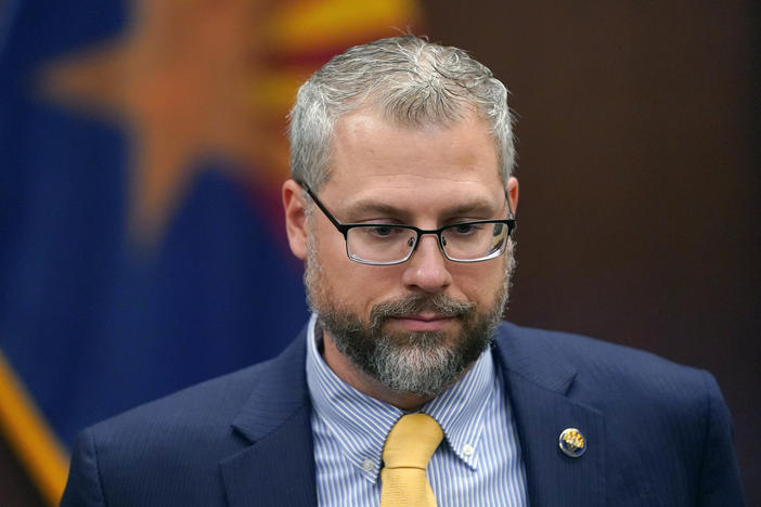Pinal County Attorney Kent Volkmer listens to complaints while addressing Election Day ballot shortages in the county.