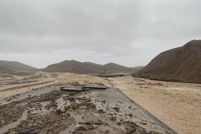 Mud Canyon Road is closed due to flash flooding in Death Valley, Calif., on Friday. Authorities say the main roadway into Death Valley National Park will remain closed as crews clean up after record-breaking rains damaged the roadway and choked it with mud, rocks and debris.