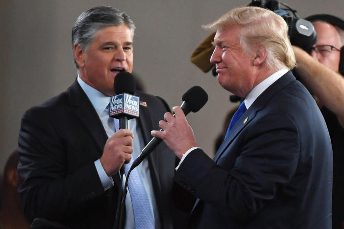 Fox News Channel and other conservative media largely leapt to former President Donald Trump's defense after the FBI searched his Mar-a-Lago resort. Here, Fox star and ally Sean Hannity (L) interviews Trump before a campaign rally in 2018 in Las Vegas.