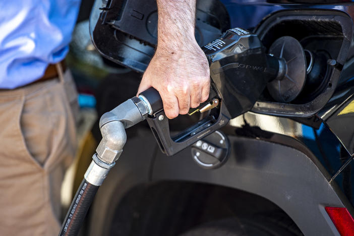 A driver pumps gas at a Gulf gas station in Lynnfield, Mass., on July 19. Gasoline prices are dropping, which is helping bring down inflation. But the cost of many other things are still climbing.