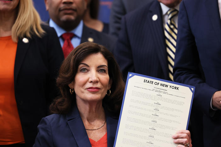 New York Gov. Kathy Hochul announced that she is pledging $10 million to establish new teams in every county and in New York City dedicated primarily to combat domestic terrorism. Here, Hochul holds up signed legislation as she is surrounded by lawmakers during a bill signing ceremony at the Northeast Bronx YMCA on June 6, 2022 in New York City.