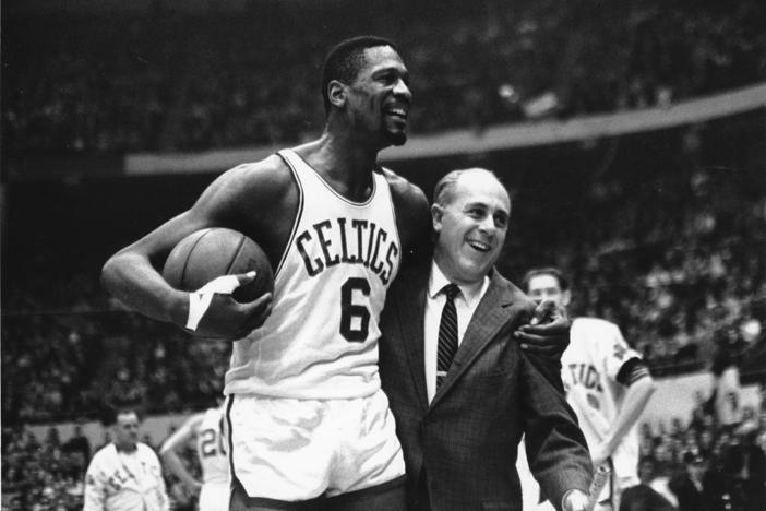 Bill Russell (left) star of the Boston Celtics is congratulated by coach Arnold "Red" Auerbach after scoring his 10,000th point in the NBA on Dec. 12, 1964.