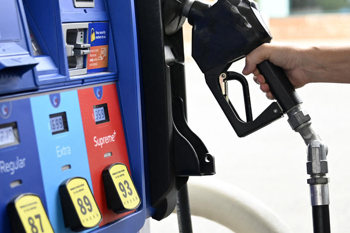 A person goes to the pump at a gas station in Arlington, Va., on July 29. The national average price of gasoline fell below $4 a gallon on Thursday.