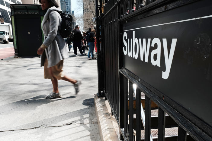 People walk by a subway stop in midtown Manhattan in New York City on April 13. Some of the city's top CEOs say they are being told by their employees that they are afraid to return to work after a recent spate of high-profile attacks.