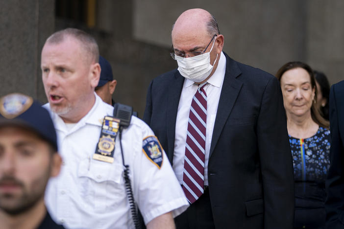 The Trump Organization's longtime chief financial officer, Allen Weisselberg (wearing mask), leaves court in New York on Friday.