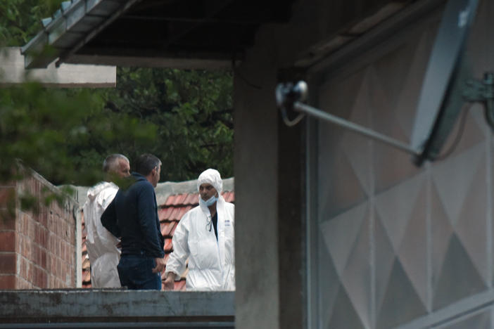 Police investigators work at the site of the attack in Cetinje, Montenegro, on Friday.