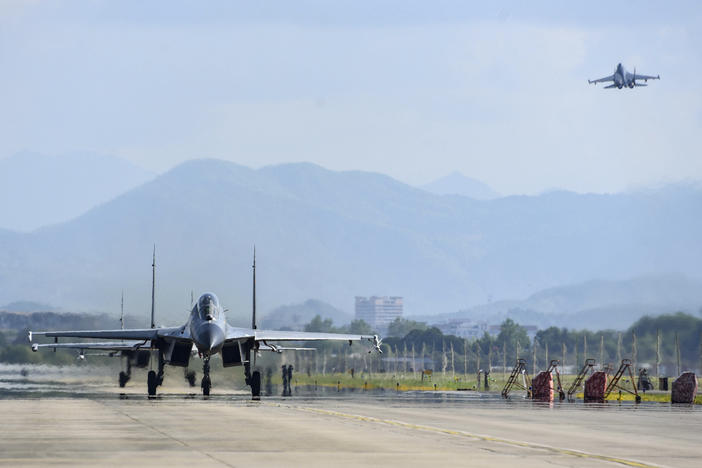 In this photo released by China's Xinhua News Agency, air force and naval aviation corps of the Eastern Theater Command of the Chinese People's Liberation Army (PLA) fly planes at an unspecified location in China on Aug. 4.