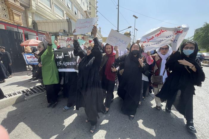 Women march down a main street in Kabul on Saturday, two days before the one-year anniversary of the Taliban takeover.